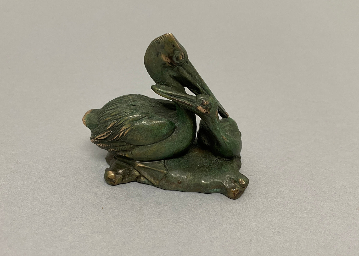 Pelican with Chick and Three Fish