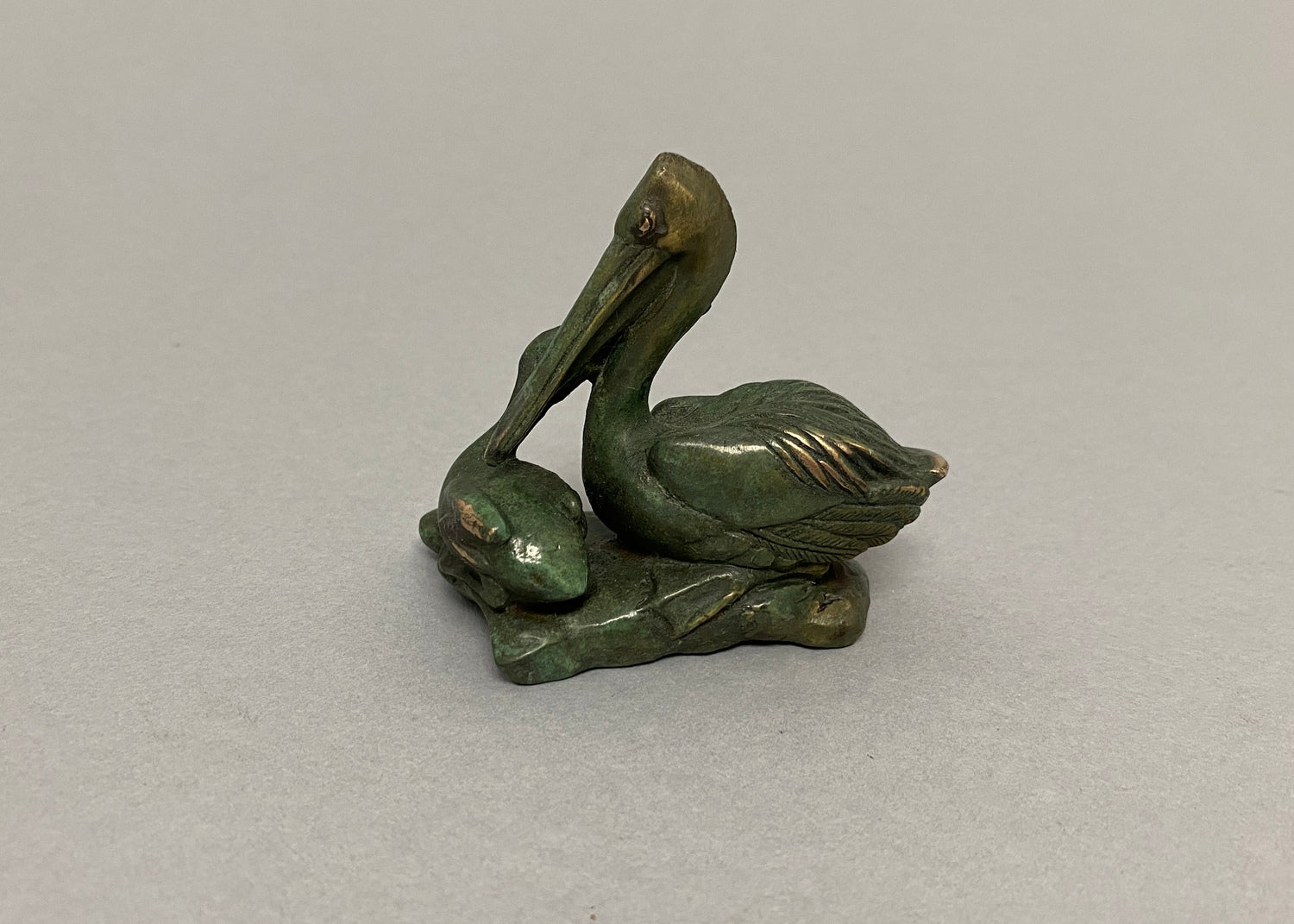 Pelican with Chick and Three Fish